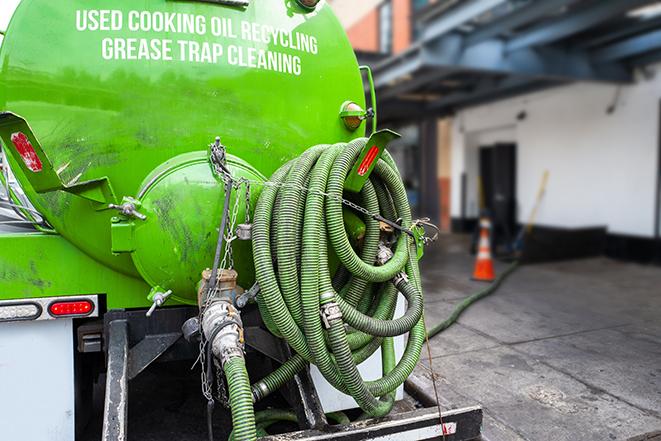 a service truck pumping grease from a restaurant's grease trap in Los Alamos, CA